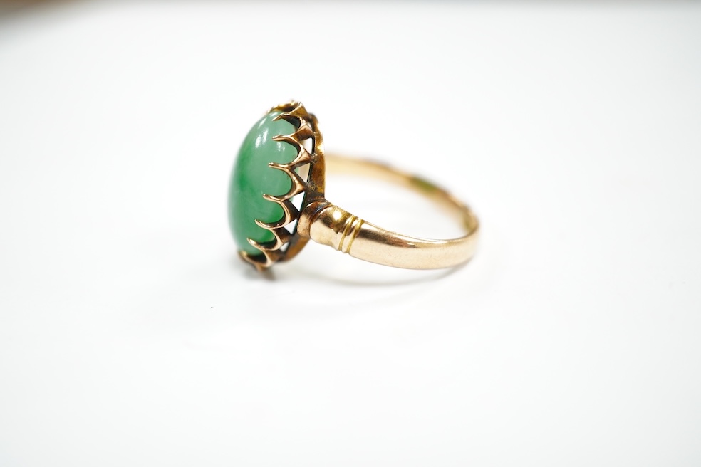 A mid 20th century yellow metal and single stone cabochon jade set ring, size Q, gross weight 5.6 grams. Condition - fair